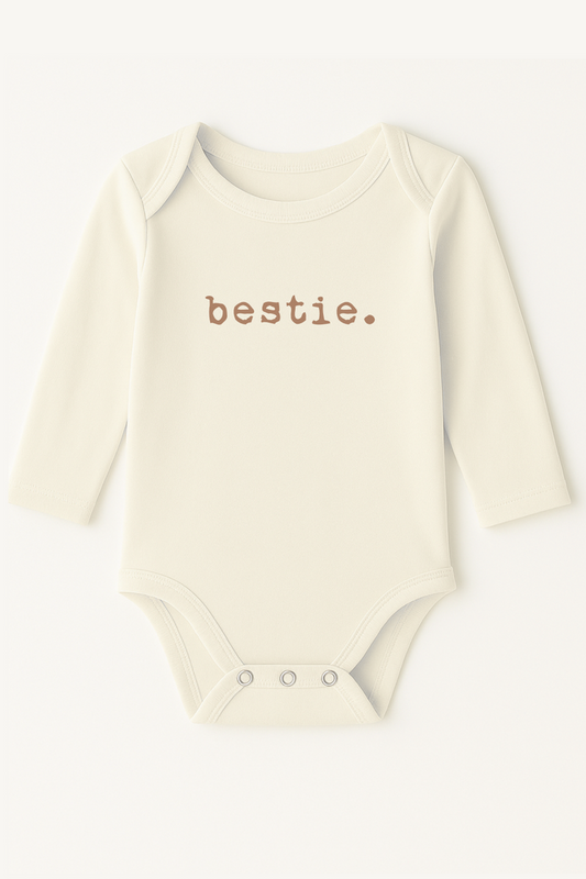 Baby onesie with 'bestie.' text on a white background