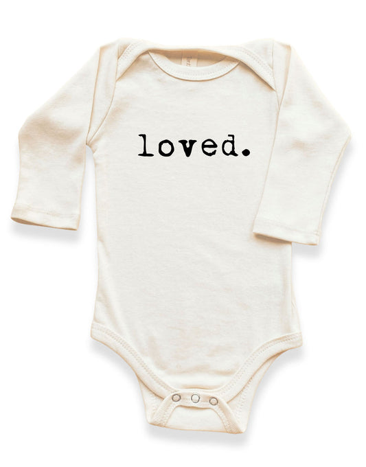 cream organic cotton baby onesie with 'loved.' text for newborn infant baby shower gift made in usa